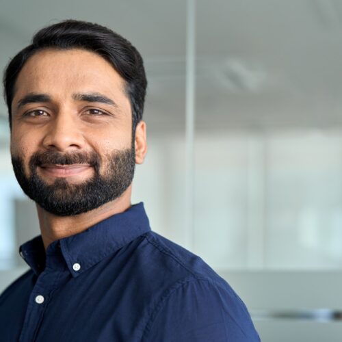 Confident Indian business man looking at camera, headshot face portrait.