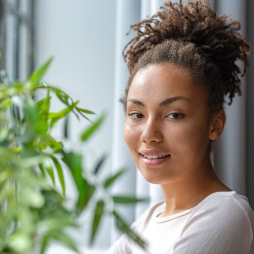 Face half-turn portrait of a beautiful woman in the interior background- Image